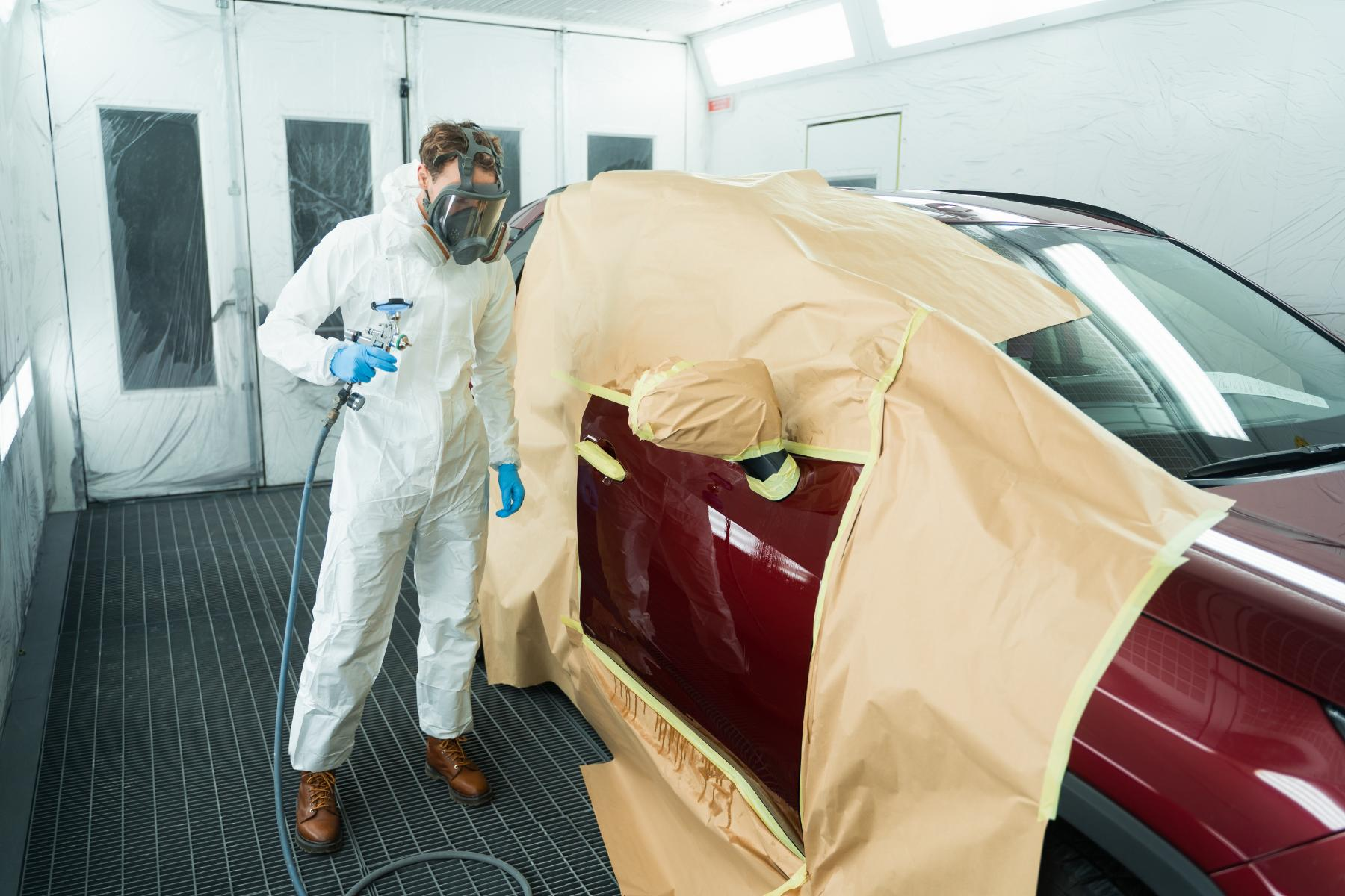 auto painter with spray gun in car painting booth 2024 10 18 17 22 35 utc